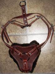 Custom Hand Crafted Latigo Leather bloodhound k-9 agitation harness available in burgundy or black with white stitching, screw type wider diameter decorative rivets that are less likely to pull loose, Stainless steel hardware used along with five stainless steel buckles for adjustment all around. Enlarged front leather pad to provide more surface area across the chest of the K-9. Available in various sizes with adjustment for a better fit